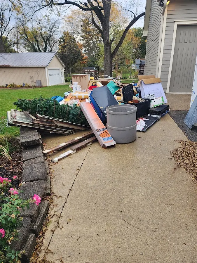 Dumpster being loaded with debris for Estate Cleanout Dumpster Rental in Lock Haven